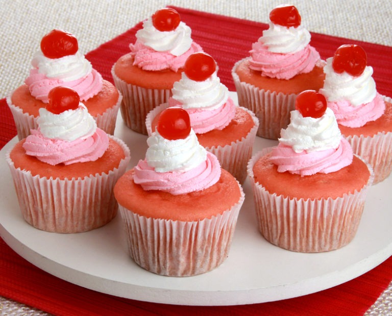 Cupcakes rosas servidos em tábua branca